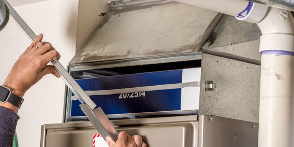 Handyman Removes Furnace Pannel Cover