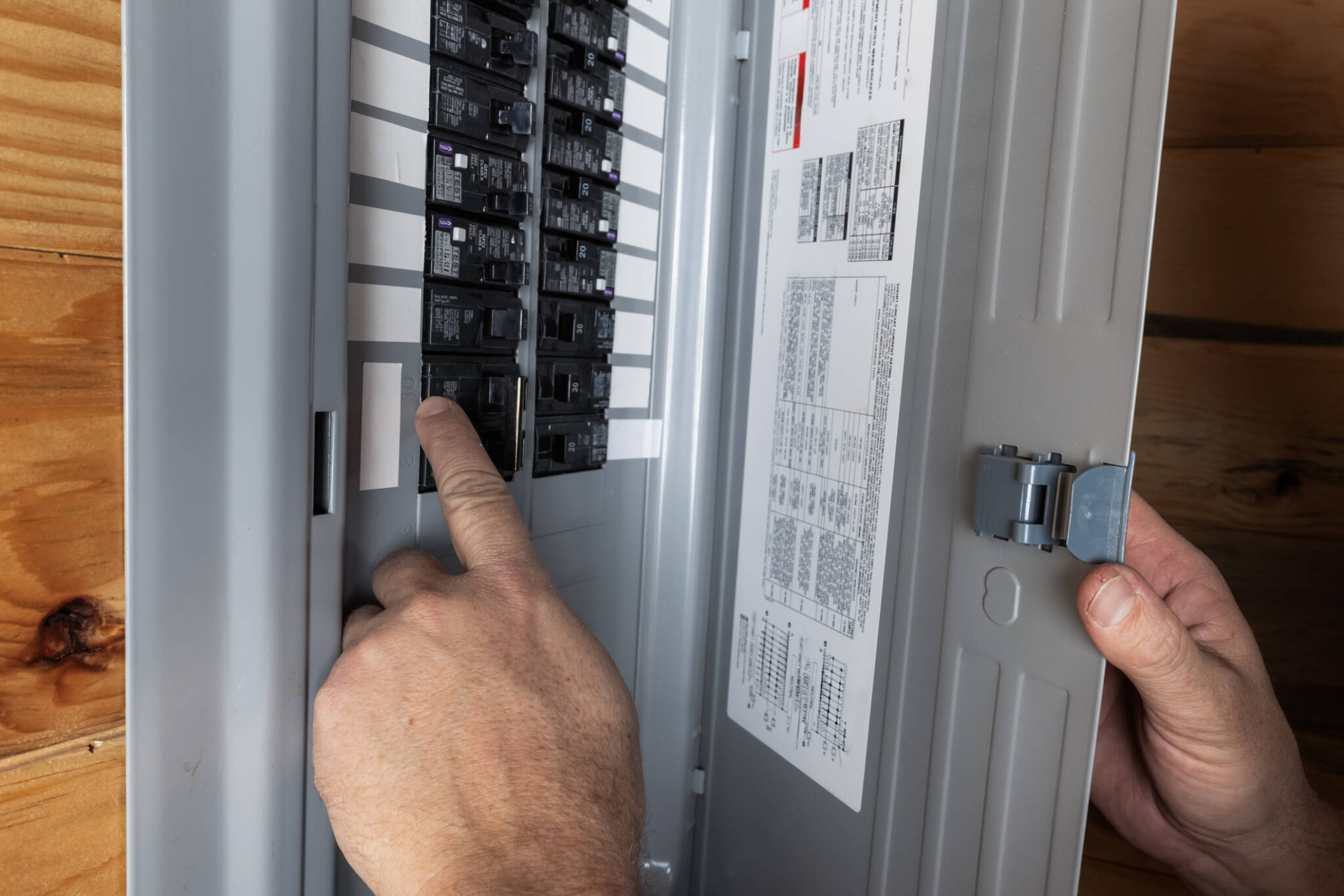Man Checking The Fuse Box At Home